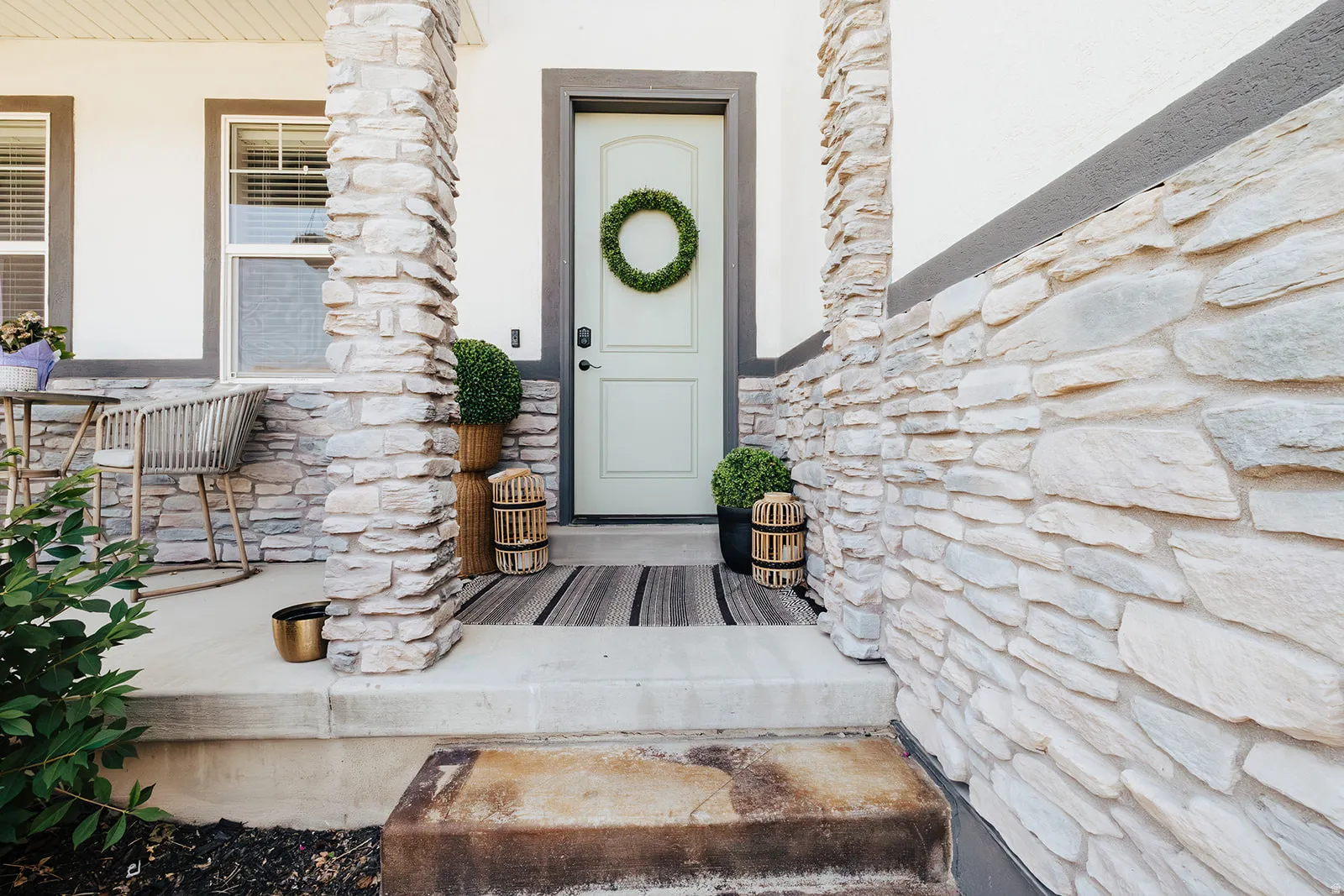 Stone veneer facade with contrasting white siding