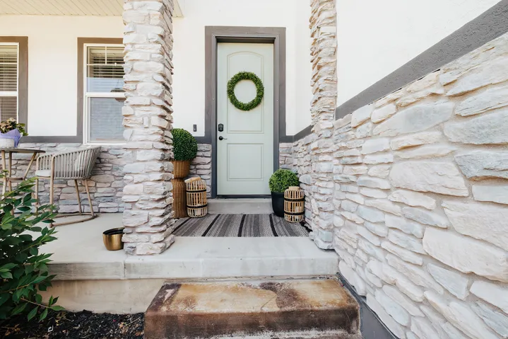 Stone veneer facade with contrasting white siding