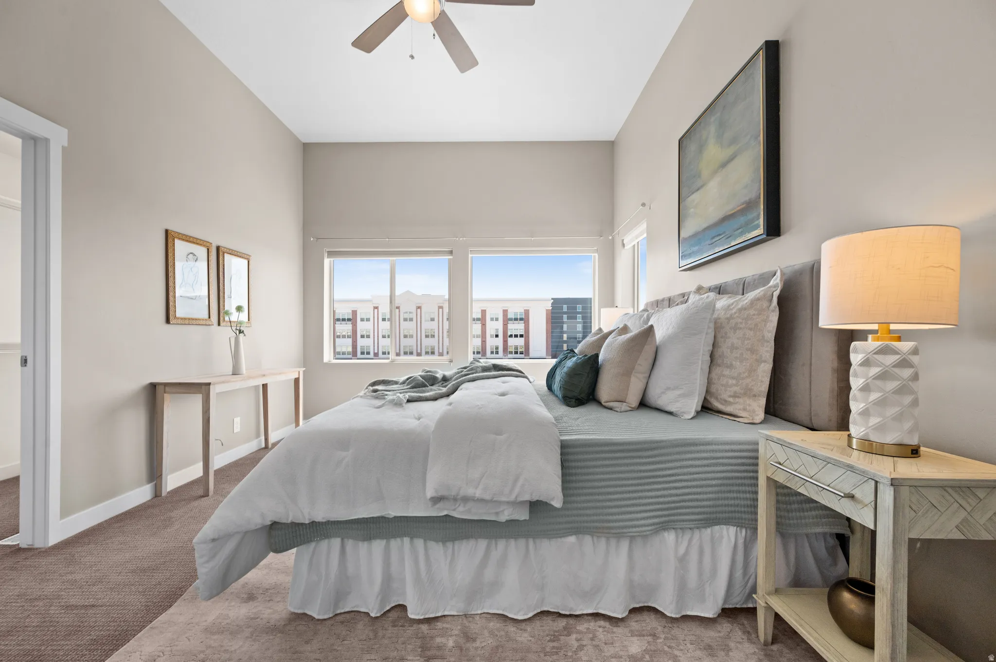 Neutral-toned room featuring a high ceiling, recessed lighting, and a ceiling fan