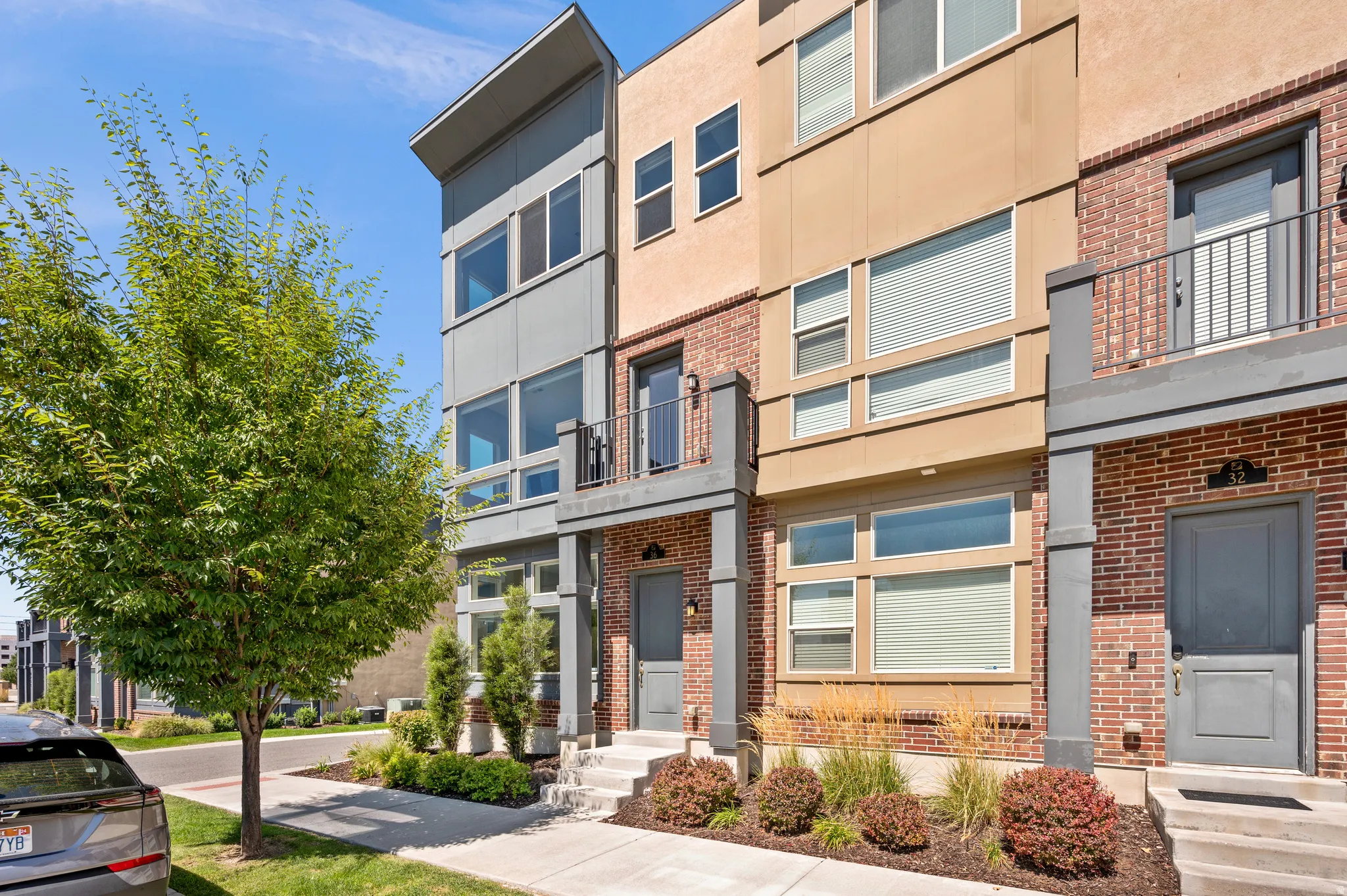 Modern multi-story exterior with brick and panel siding
