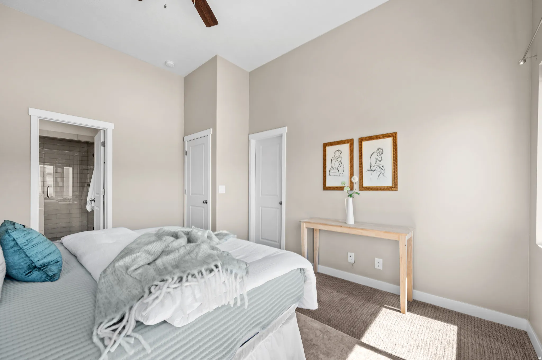 Vaulted ceilings with a ceiling fan, neutral wall colors, and plush carpet flooring