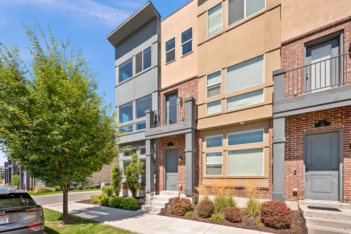 Modern multi-story exterior with brick and panel siding