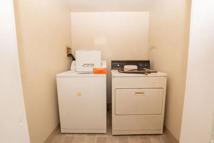 Dedicated laundry area with durable tile flooring