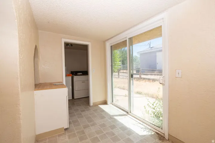 Tiled flooring with a sliding glass door providing exterior access