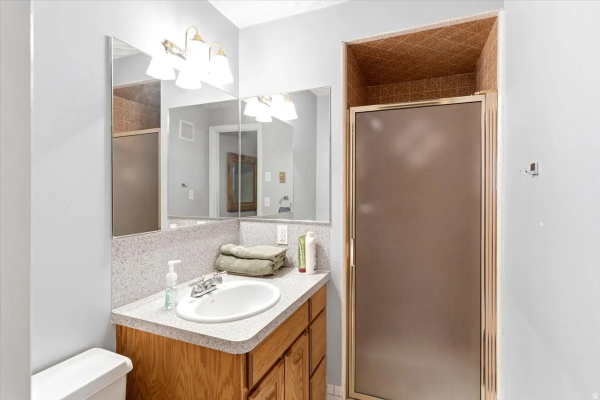 Bathroom vanity with a white oval sink set in a speckled countertop