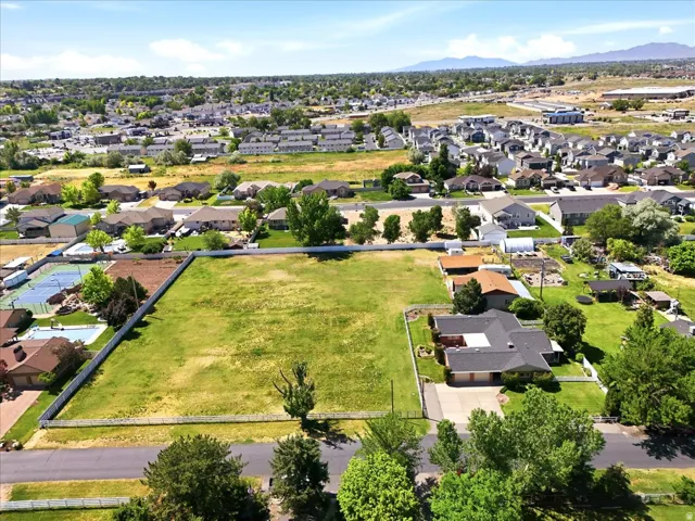 Expansive land parcel with surrounding residential properties, offering substantial development potential
