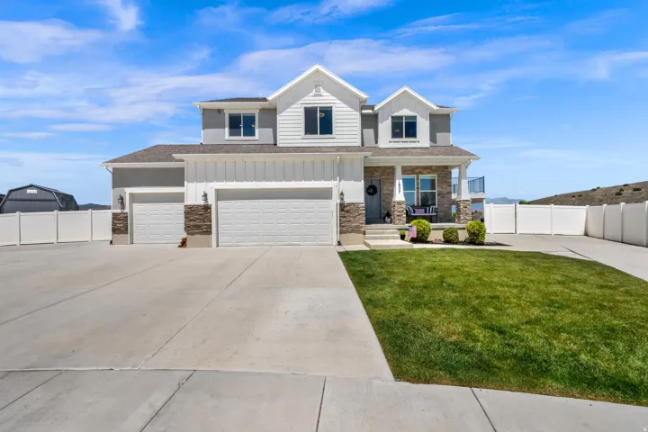 Craftsmam two-story residence featuring a combination of horizontal siding, vertical board and batten siding, and stone veneer accents, abundant parking