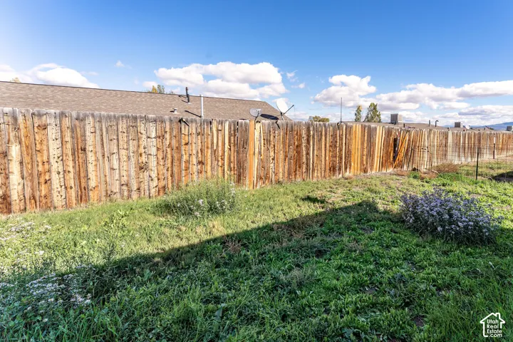 Exterior area featuring a wood-plank perimeter fence and open grounds
