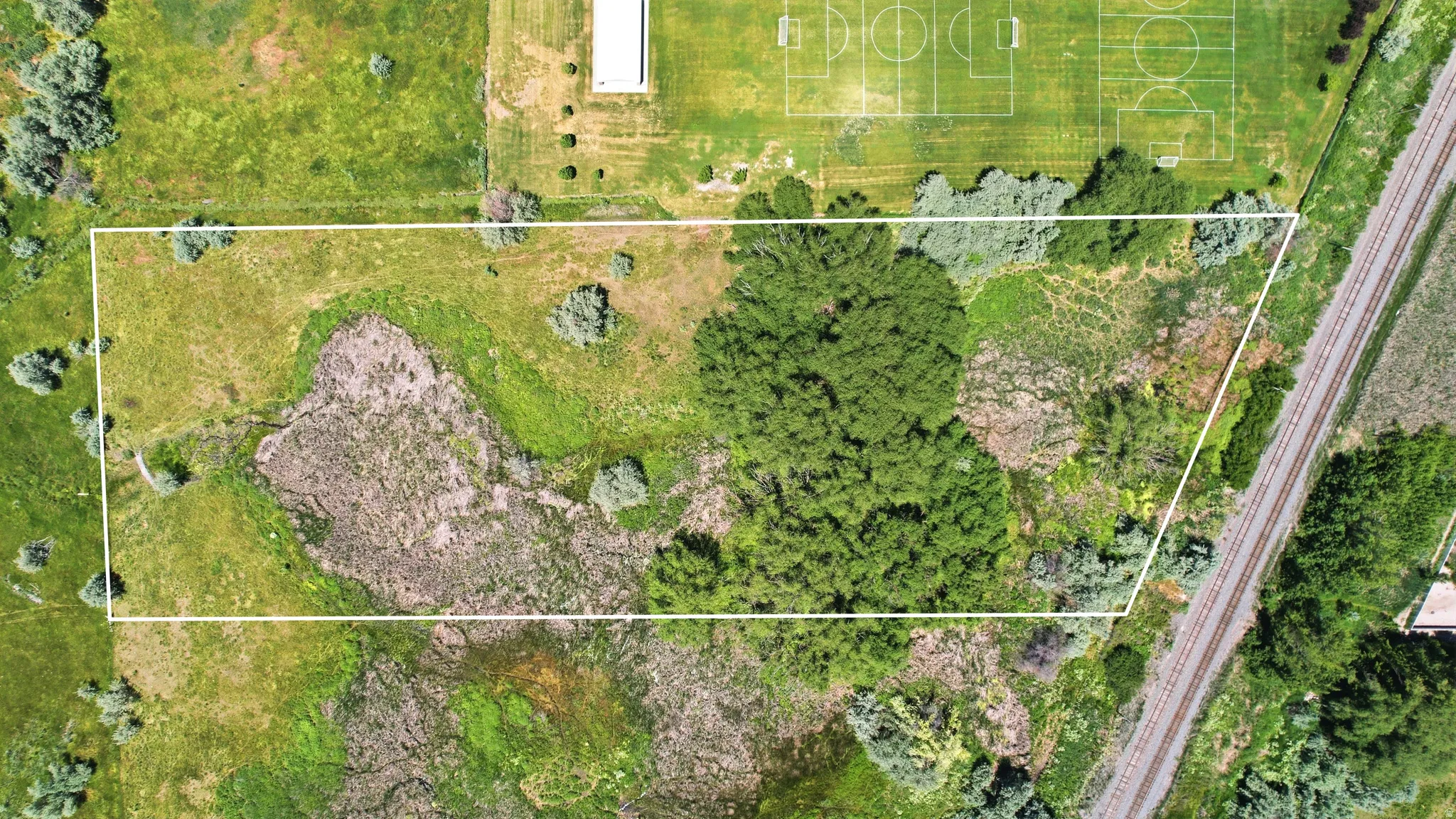 Expansive undeveloped parcel featuring varied topography and natural vegetation