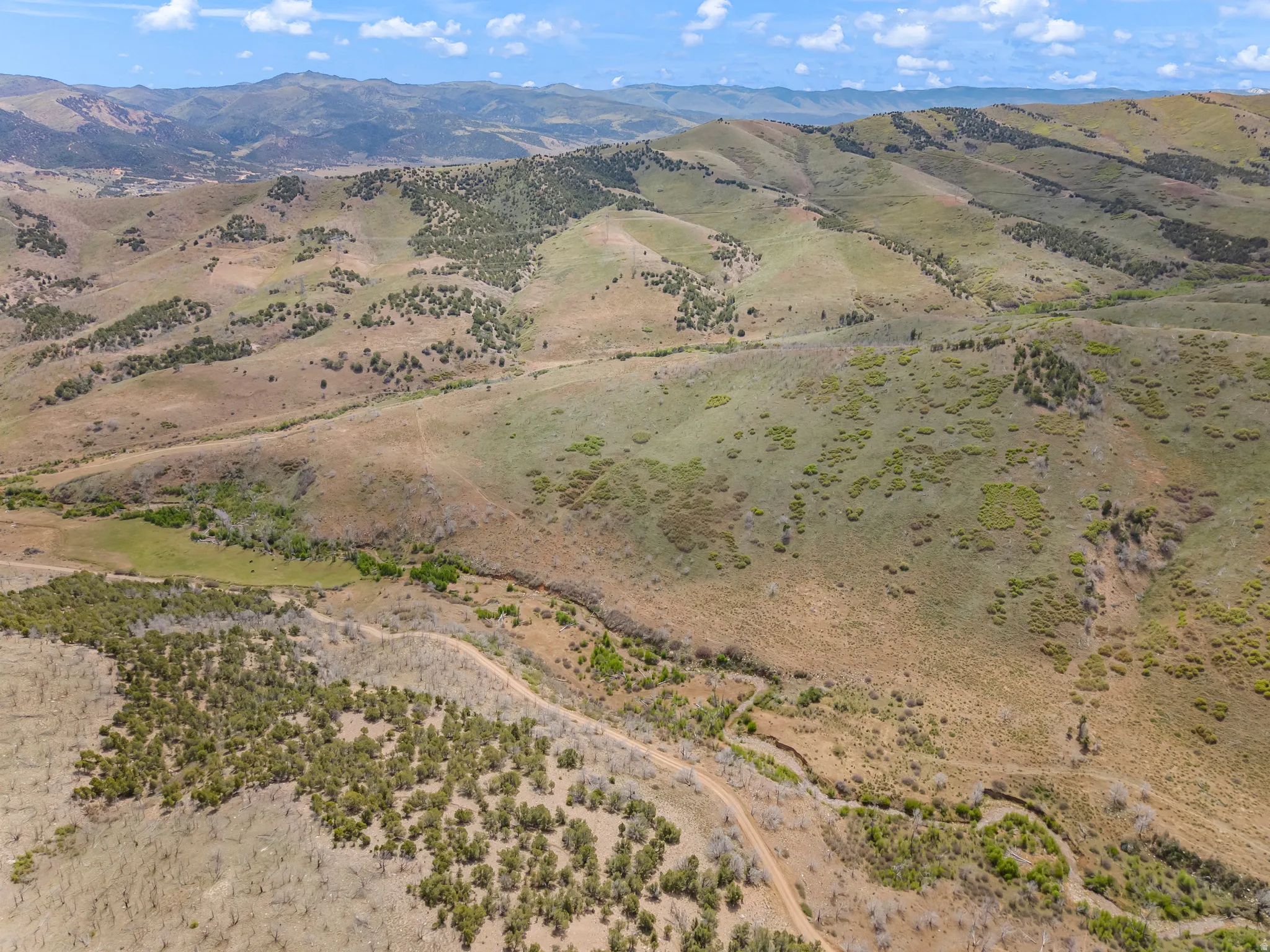 Expansive mountainous terrain with varied vegetation