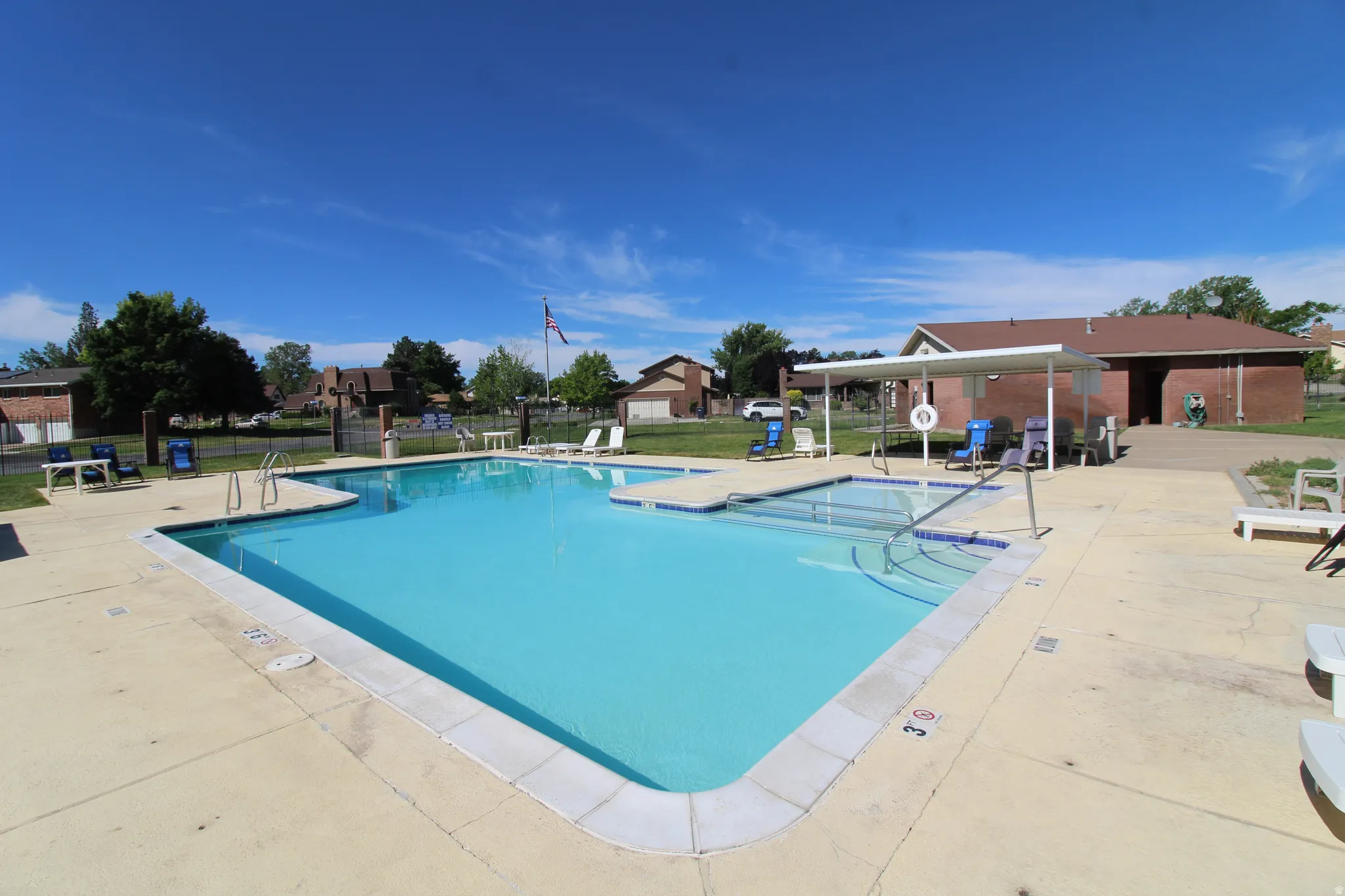 Expansive outdoor swimming pool with a concrete deck surround
