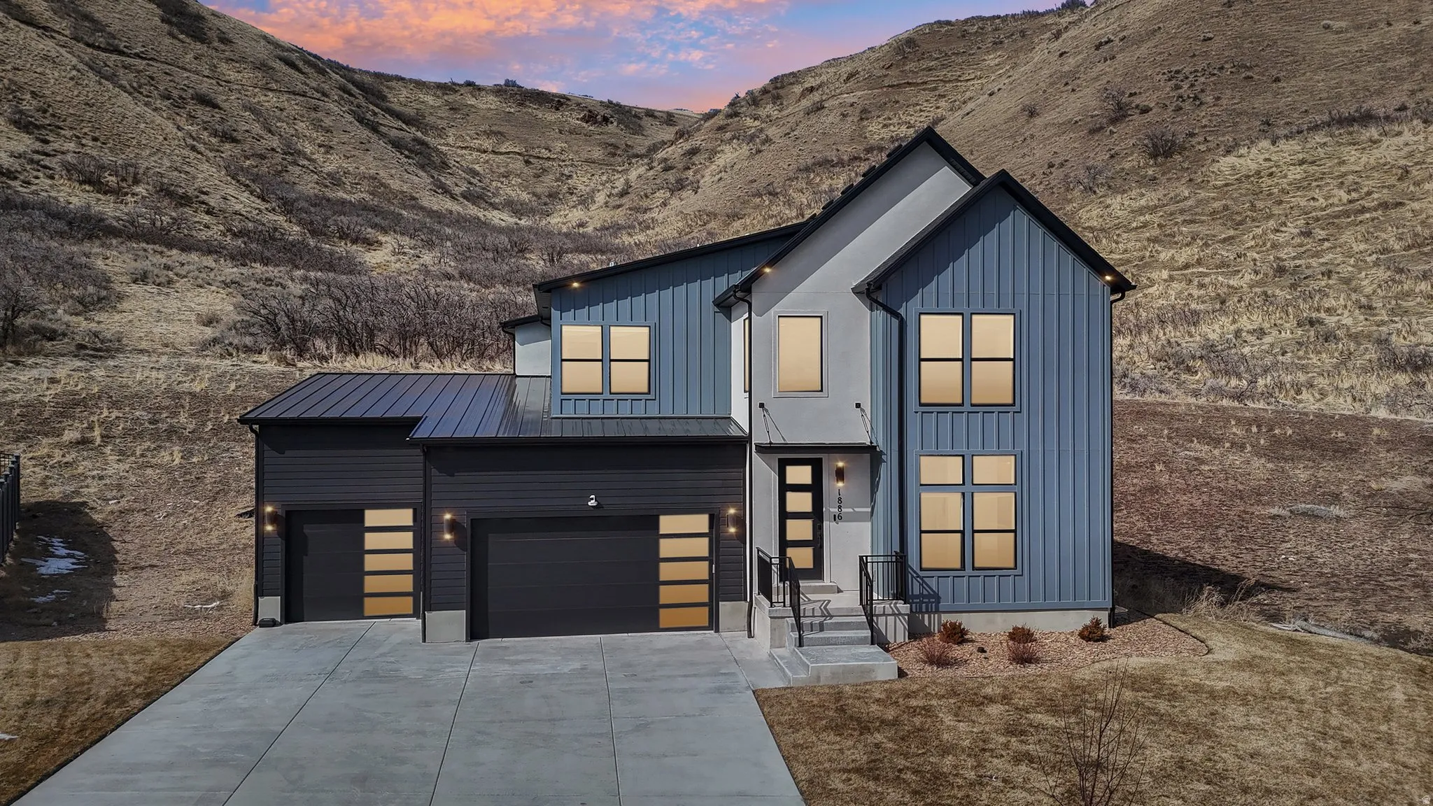 Contemporary residence featuring a striking blue and gray facade with vertical siding accents