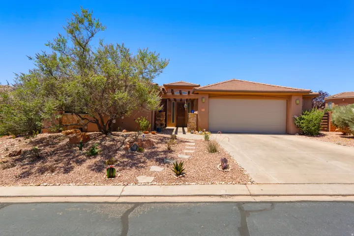 Southwestern-style stucco exterior with a tile roof and an attached two-car garage