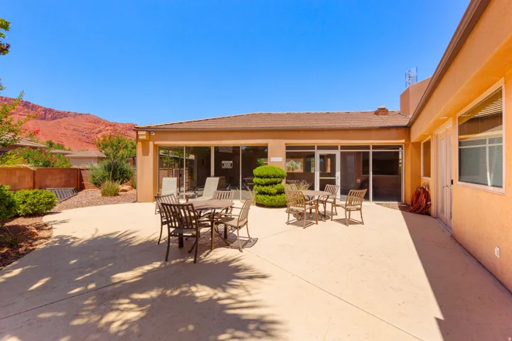 Expansive concrete patio with multiple outdoor dining areas
