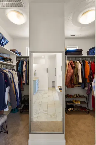 Walk-in closet with carpet flooring and integrated shelving