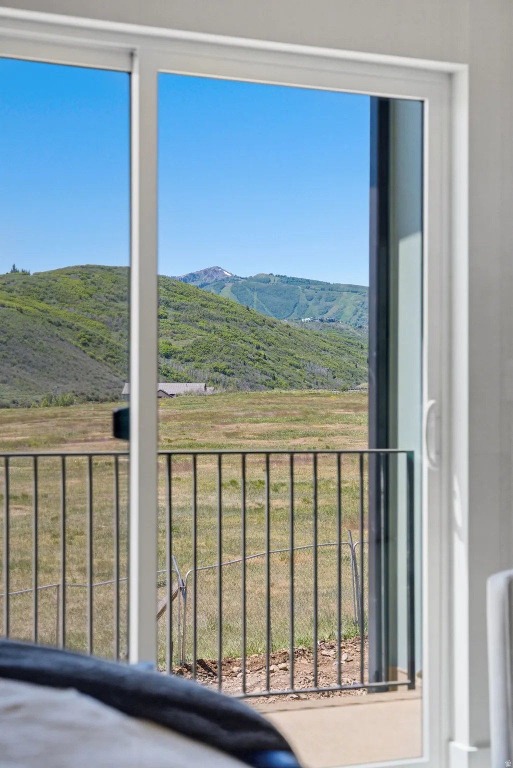 Sliding glass door opening to a private balcony with metal railing