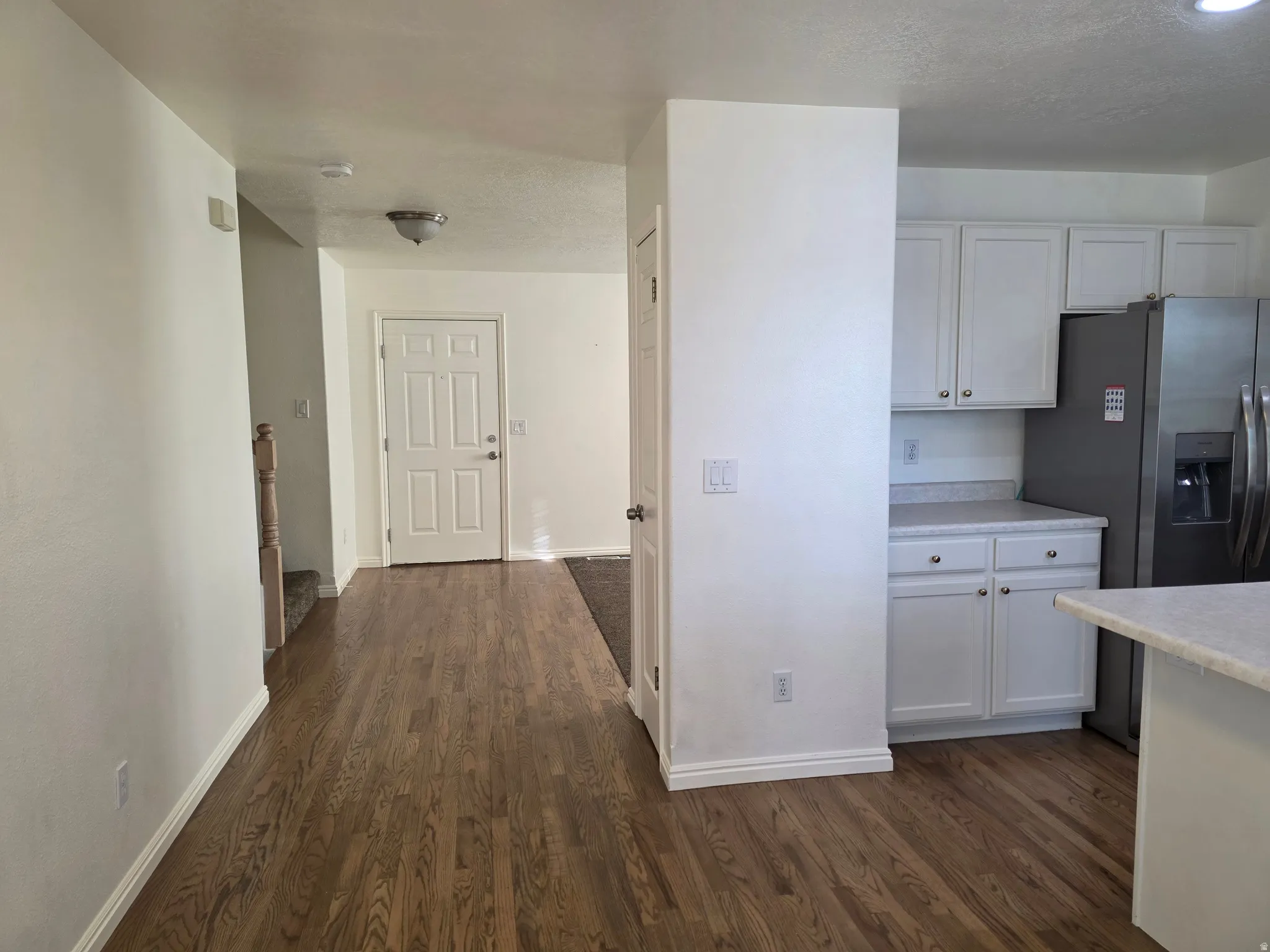 Hardwood-style flooring extends from the entryway throughout the main level