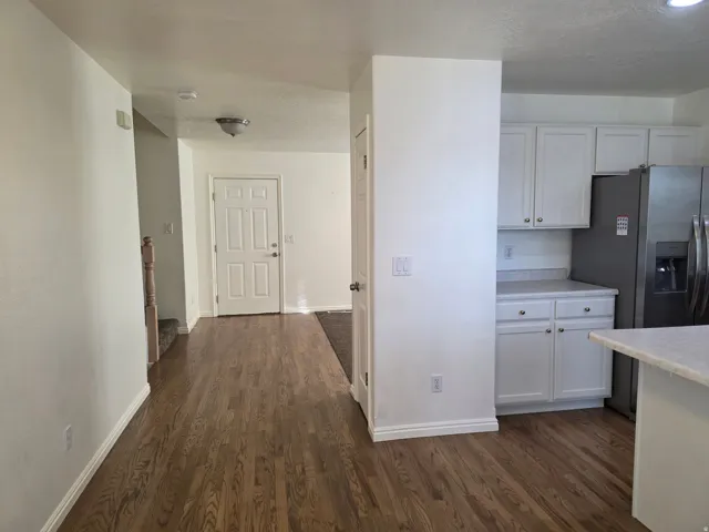 Hardwood-style flooring extends from the entryway throughout the main level