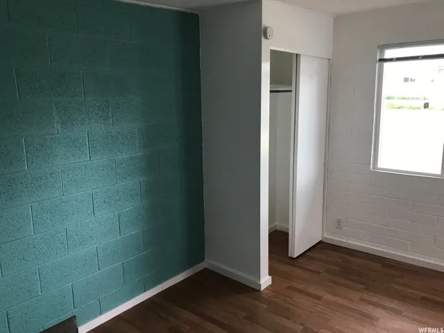Interior room featuring a teal painted cinder block accent wall