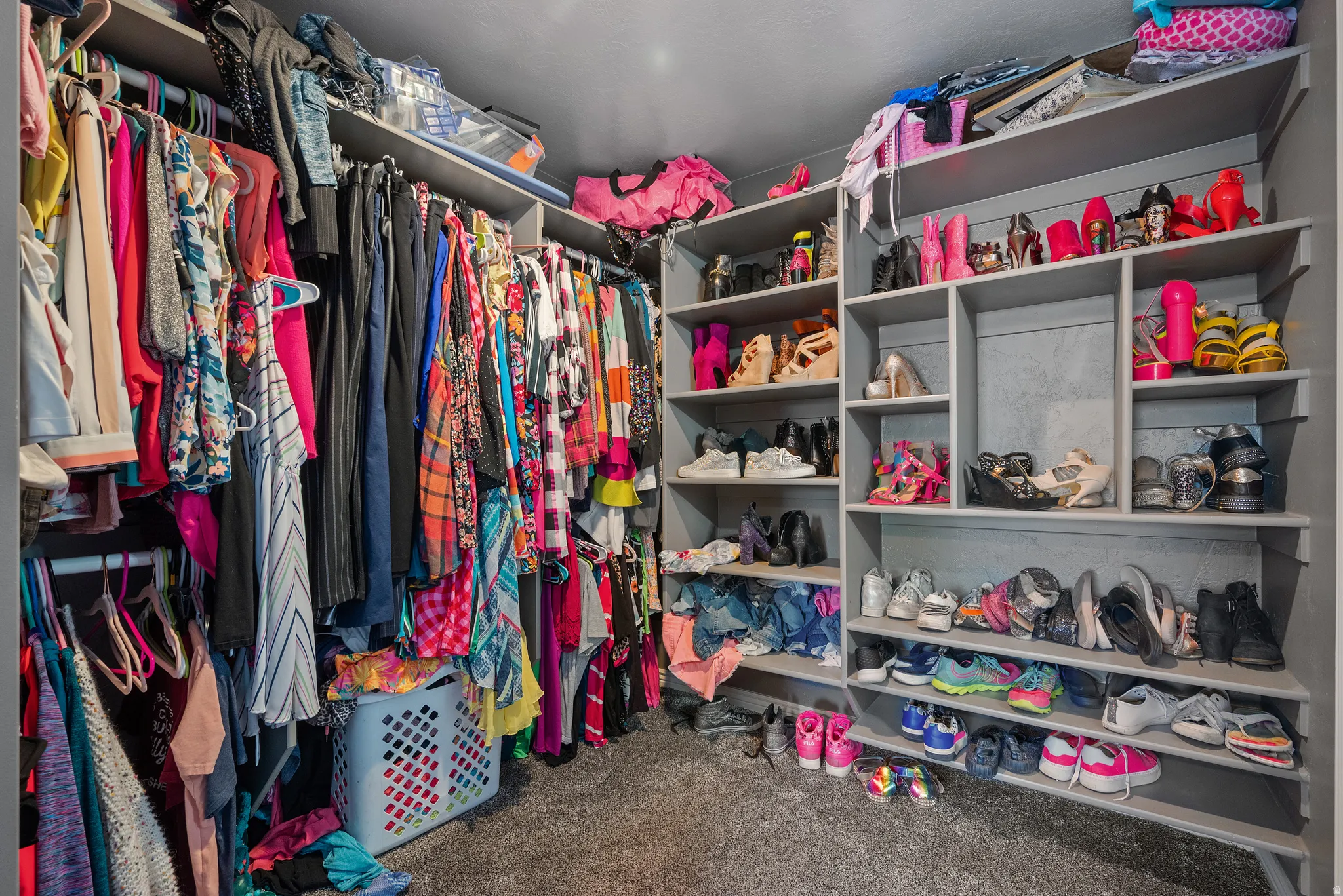 Custom closet system featuring extensive shelving and hanging rods