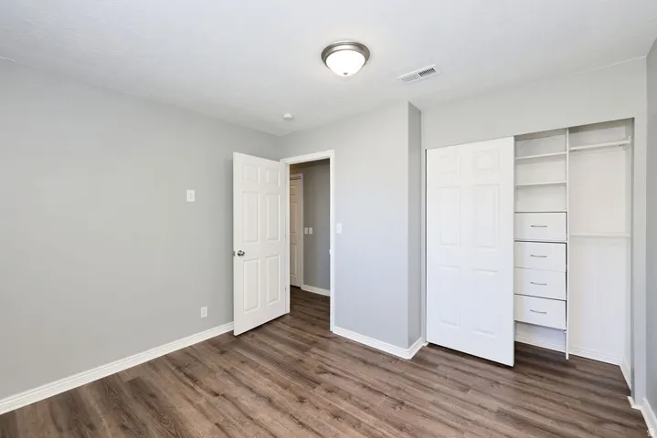 Neutral gray wall finishes complement the wood-finish flooring