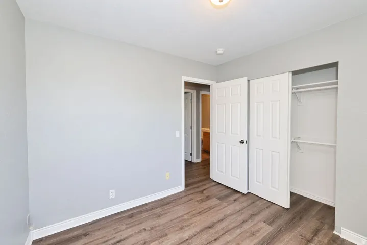 Interior room featuring wood-finish flooring and light gray walls