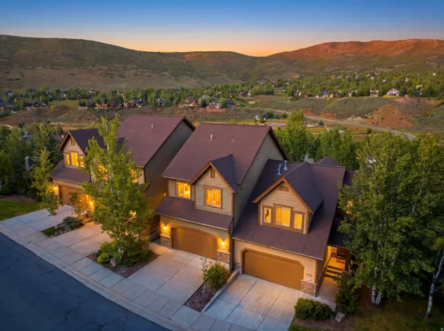 Attached multi-level residences featuring warm exterior siding and stone accents