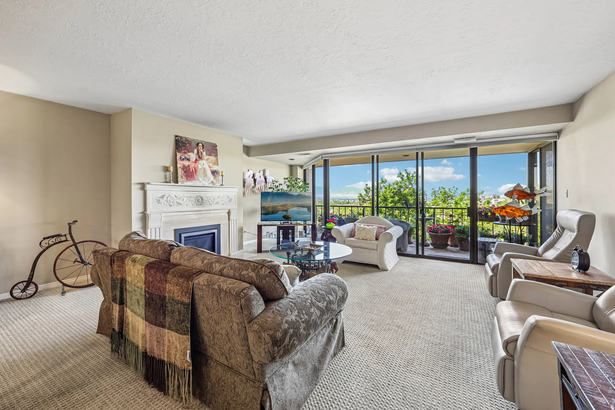 Living area featuring wall-to-wall carpeting, a decorative fireplace with an ornate mantelpiece, and neutral-toned walls