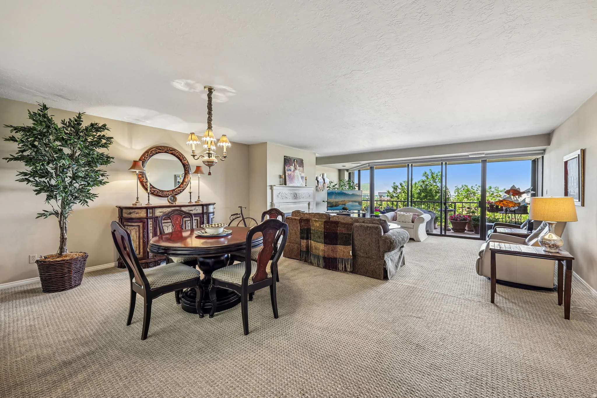 Open concept living and dining area featuring a full wall of glass doors opening to an exterior balcony