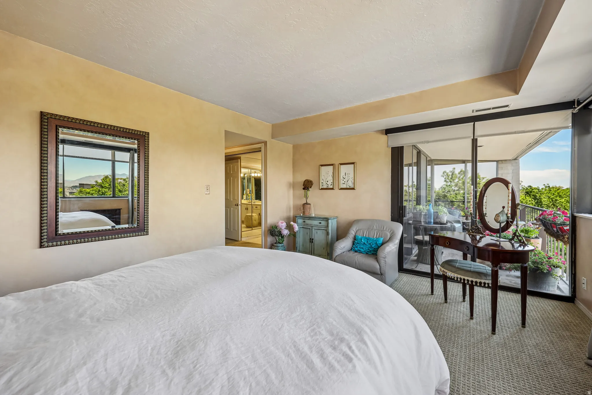 Carpeted interior space with direct access to a private balcony