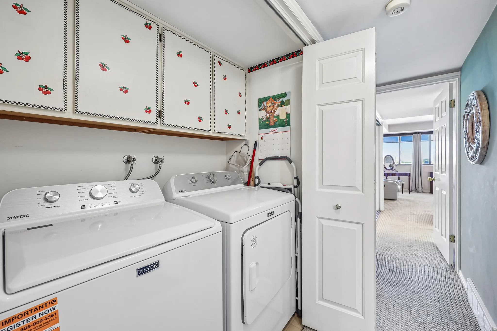 Dedicated laundry area featuring upper cabinetry for storage