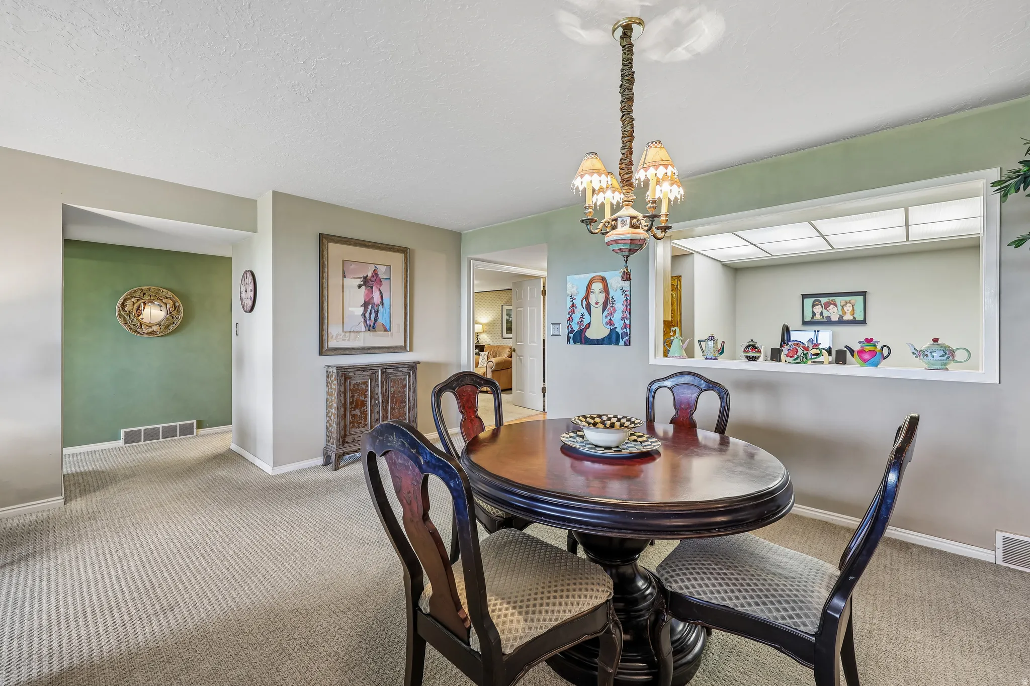 Defined dining area featuring a decorative chandelier with multiple shaded lights