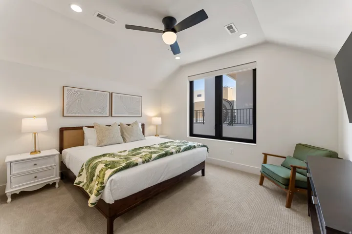 Carpeted room featuring a ceiling fan with integrated lighting, recessed lighting, and a large window with black framing