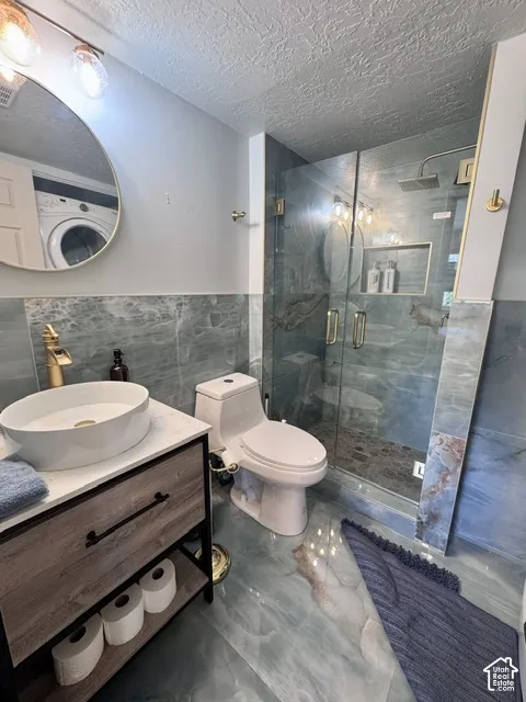 Bathroom featuring blue-toned stone-look flooring and wall tiles