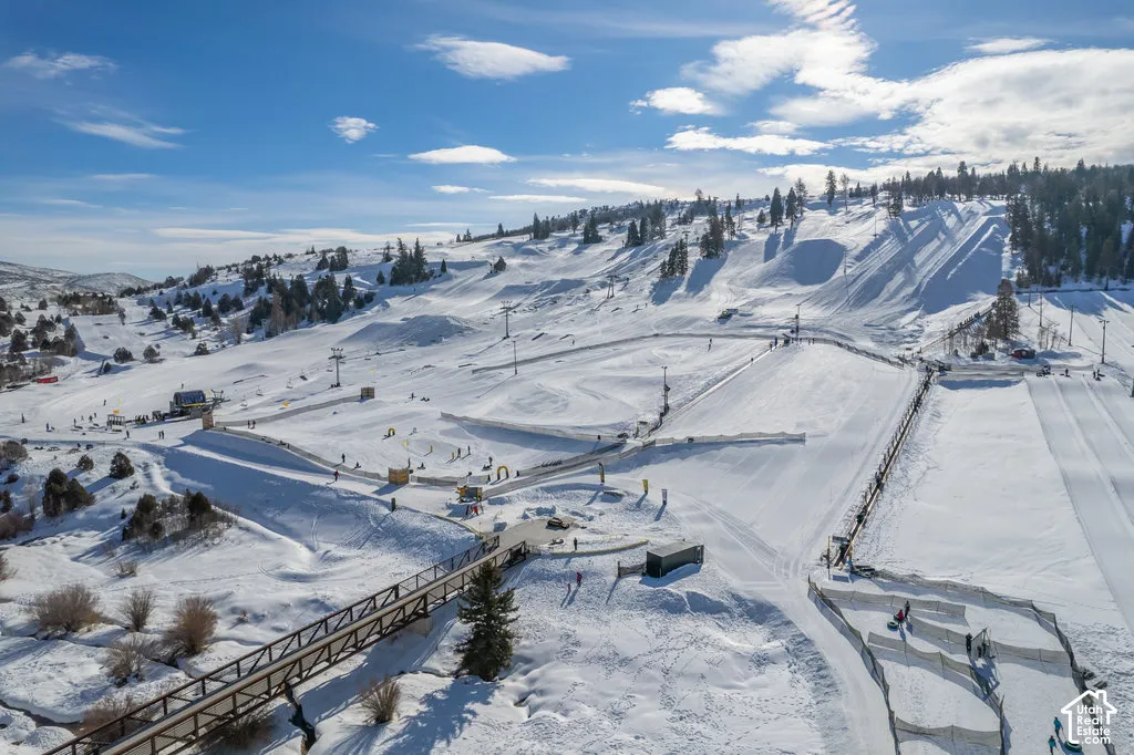 Expansive snow-covered landscape featuring multiple ski slopes and tubing lanes