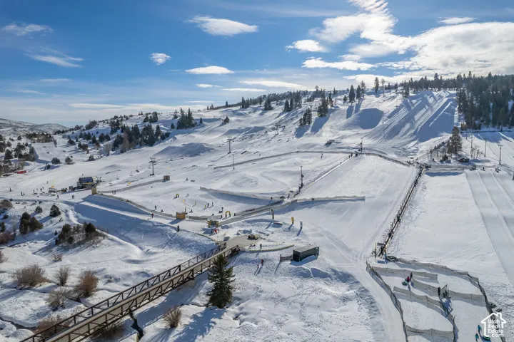 Expansive snow-covered landscape featuring multiple ski slopes and tubing lanes