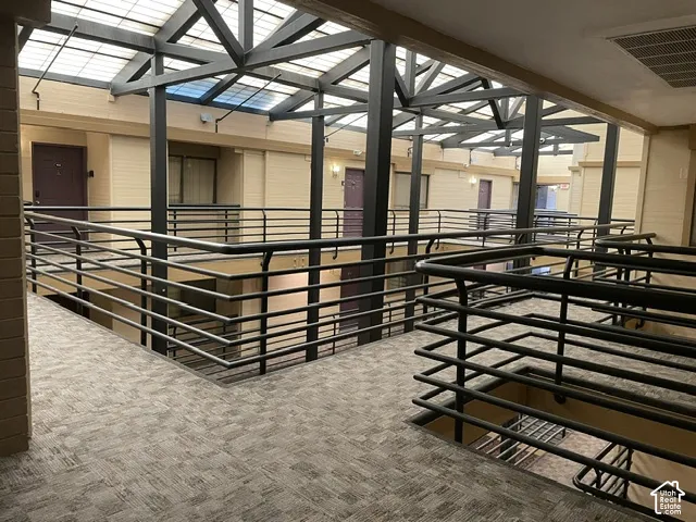 Multi-level interior corridor with patterned carpet flooring