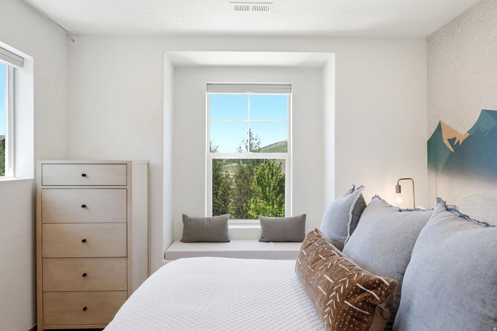 Recessed window alcove with a built-in cushioned bench and a large window