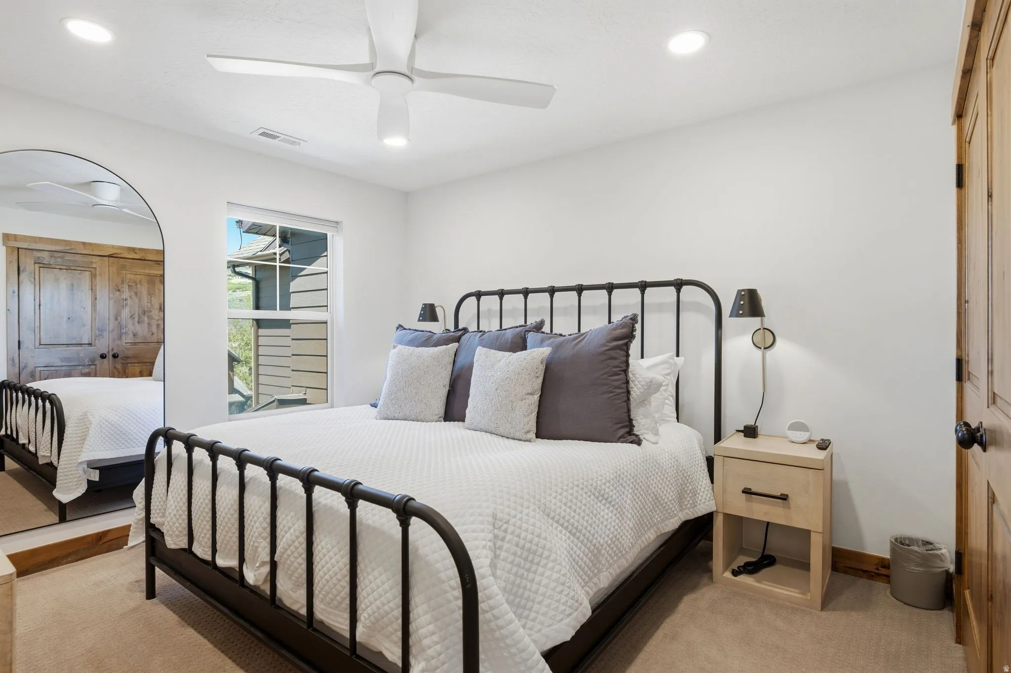 Carpeted room featuring a window, recessed lighting, and a ceiling fan