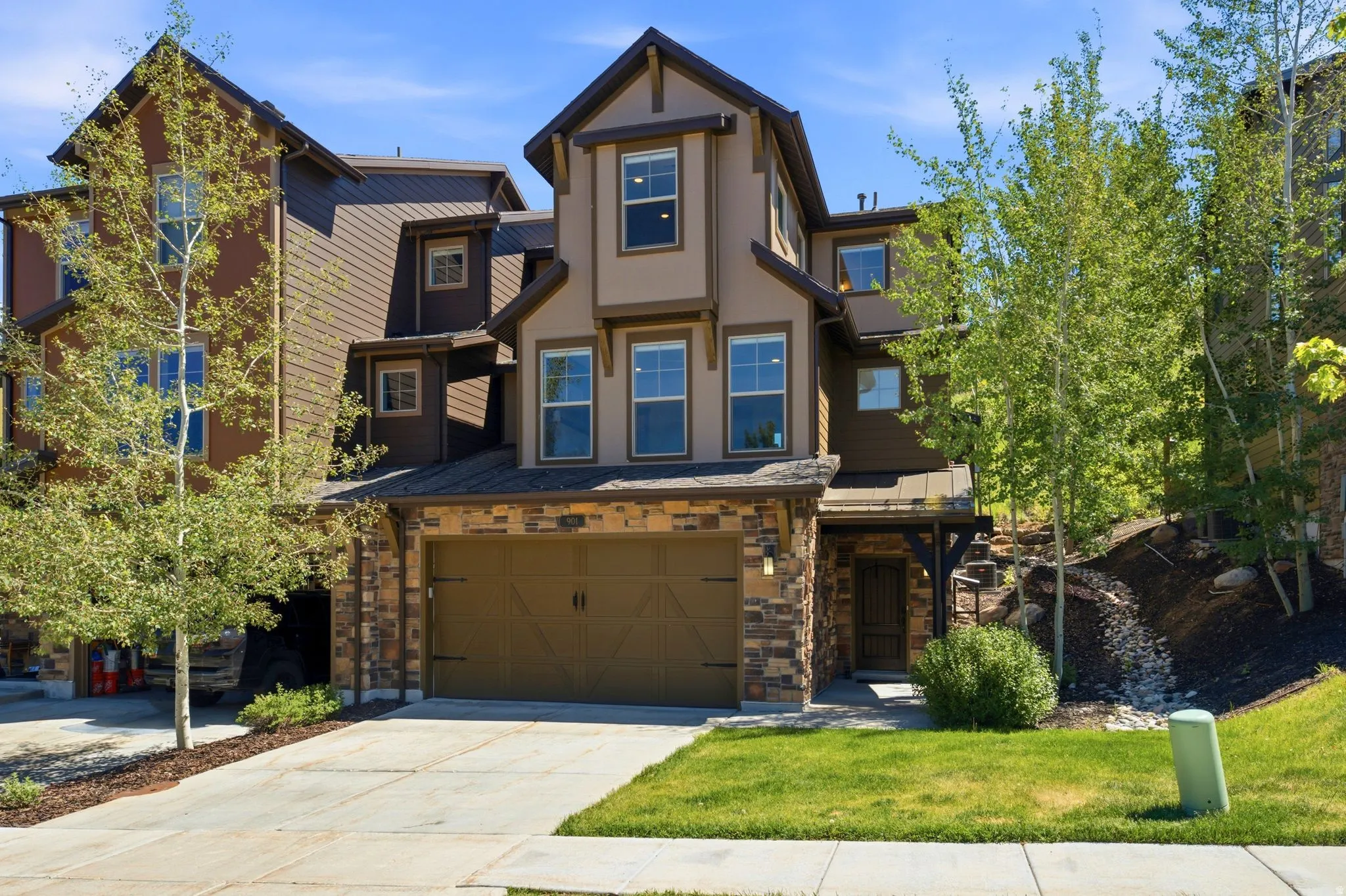 Three-story facade featuring stone and siding finishes