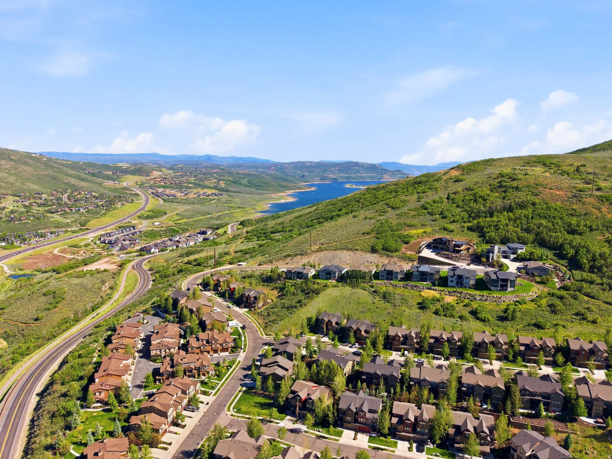 Aerial perspective showcasing a residential community nestled in a mountainous landscape