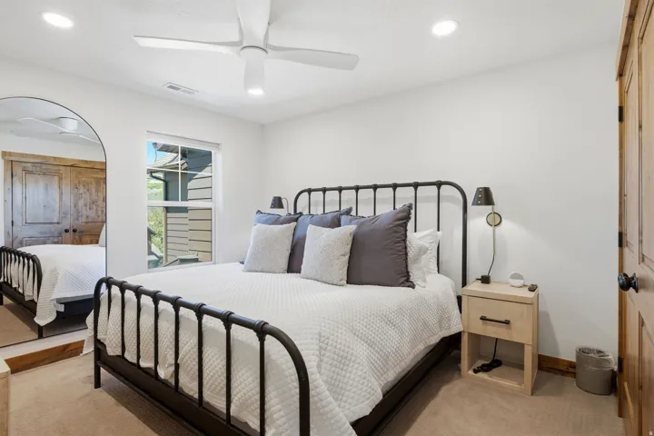 Carpeted room featuring a window, recessed lighting, and a ceiling fan