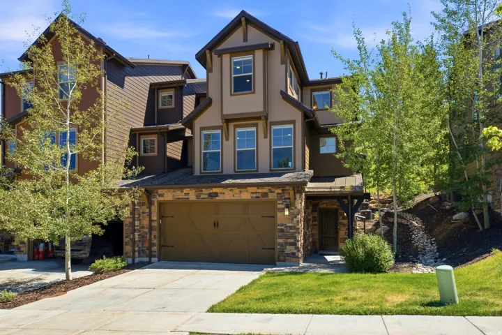 Three-story facade featuring stone and siding finishes