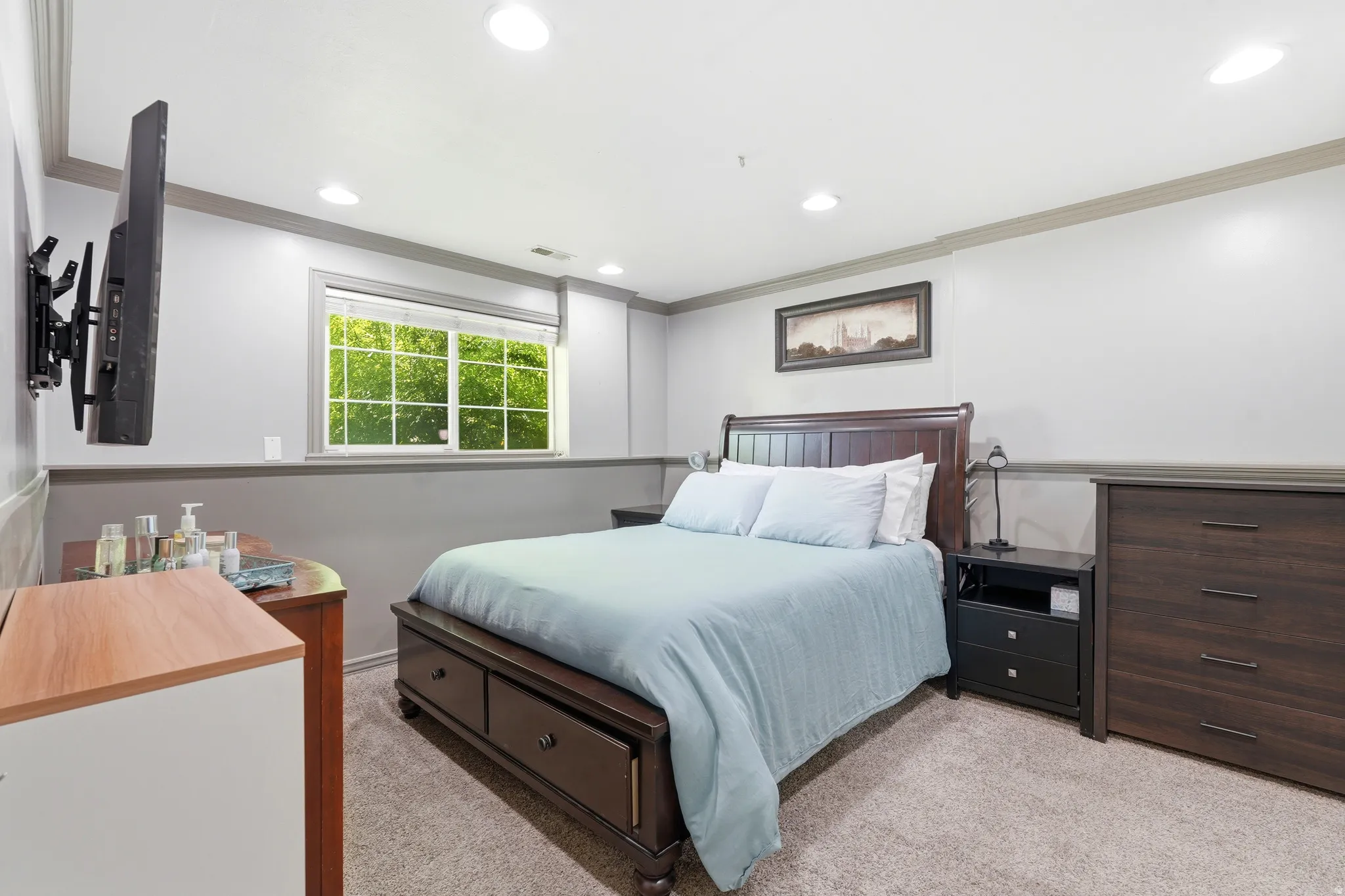 Recessed lighting illuminates the space, featuring a window with exterior views