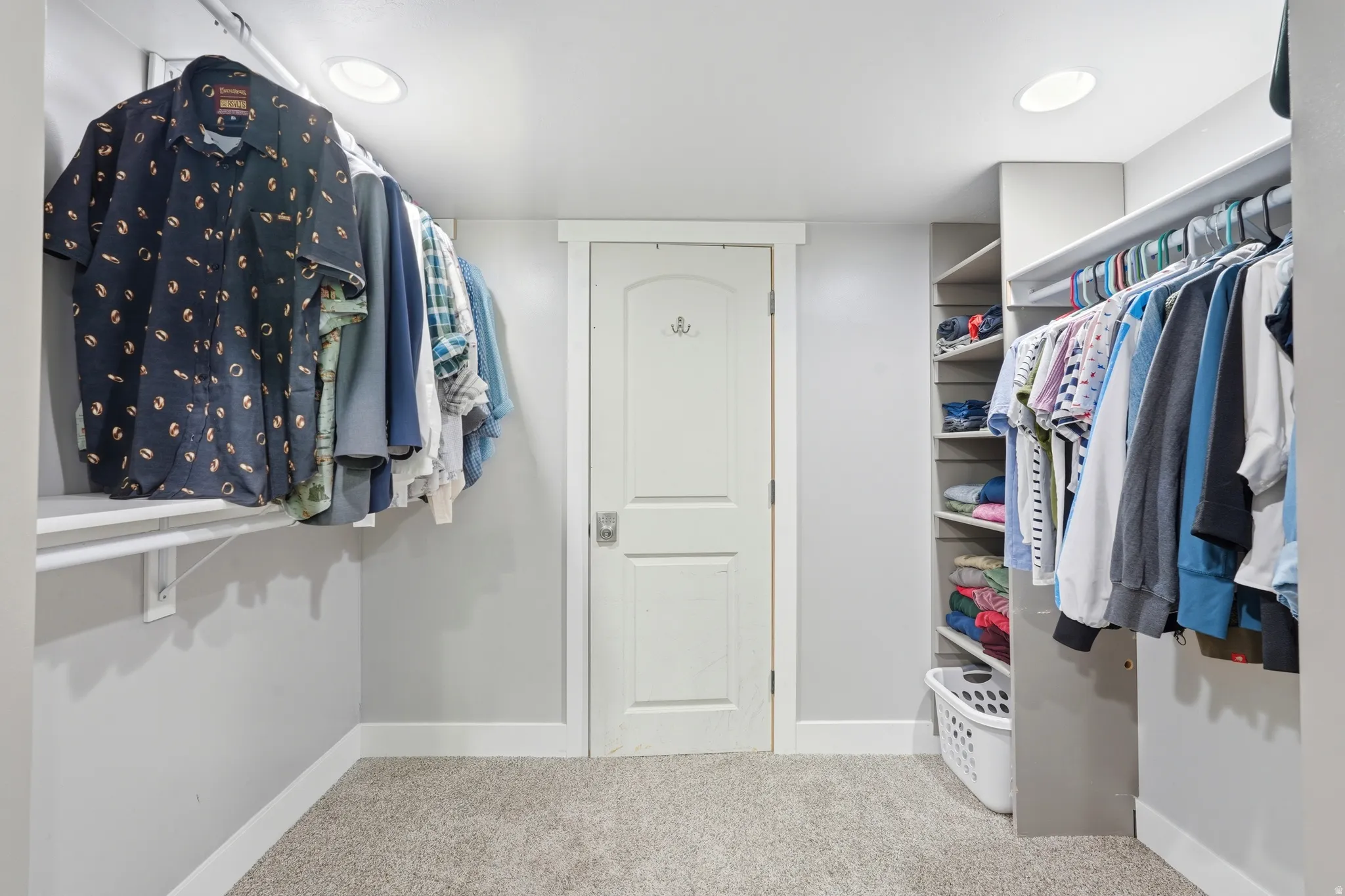 Spacious walk-in closet featuring carpet flooring and recessed lighting