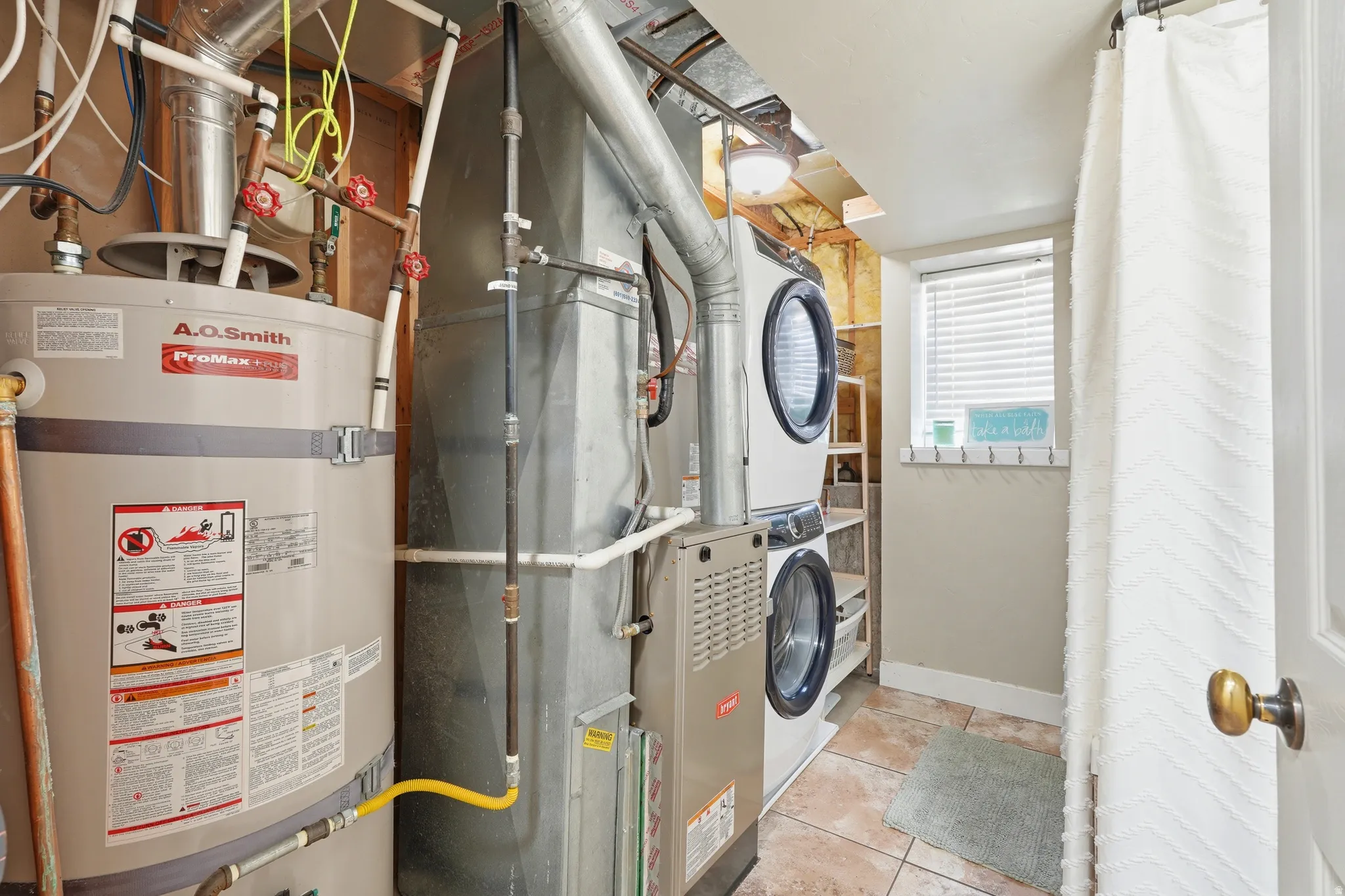 Dedicated utility area featuring a water heater and furnace