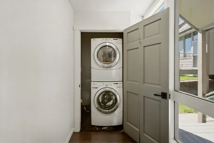 Dedicated laundry closet featuring a stacked washer and dryer