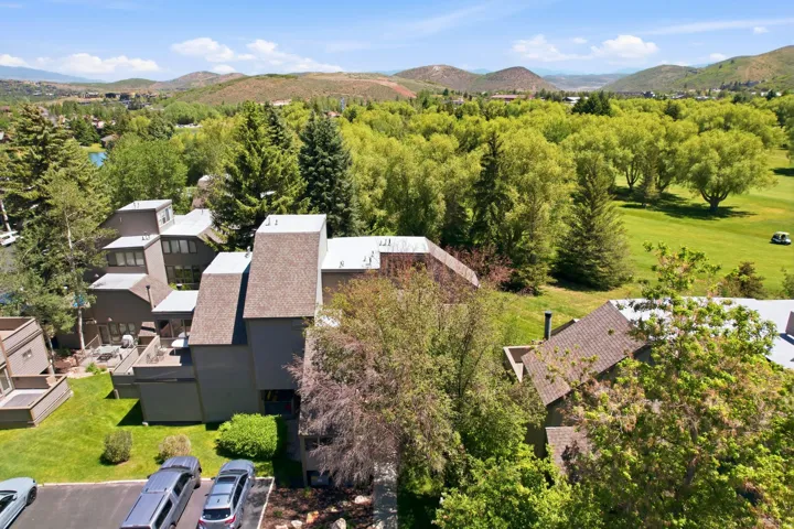 Contemporary multi-level building with shingled roofing and multiple balconies