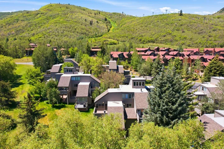 Multi-level property featuring sloped roofs and multiple balconies