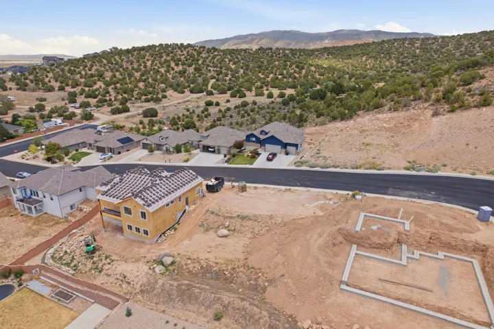 Developing residential area featuring a new construction home with an unfinished exterior